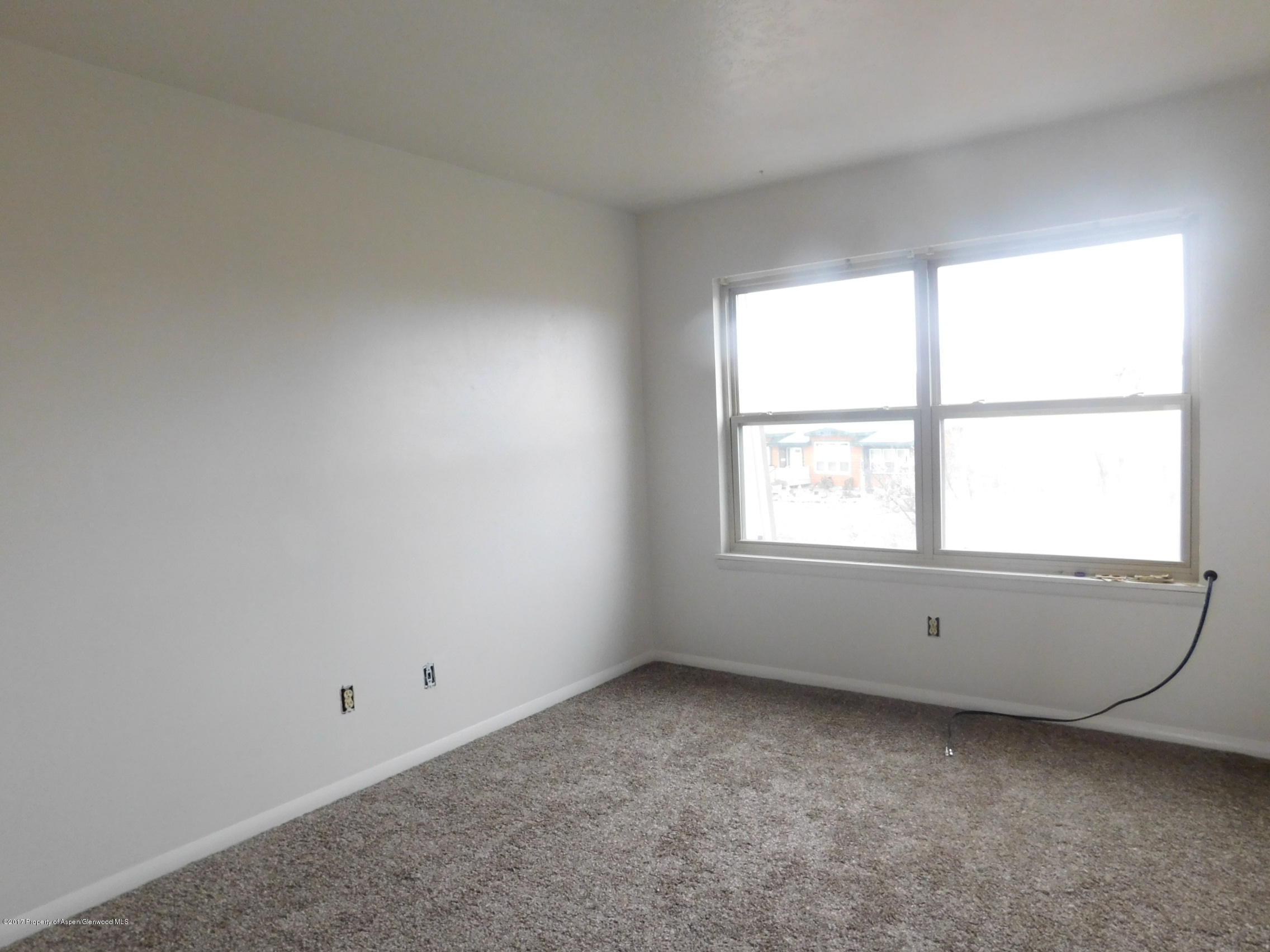 1393 West 2nd Street Craig, CO 81625 - Photo 5 of 16 an empty room with a window