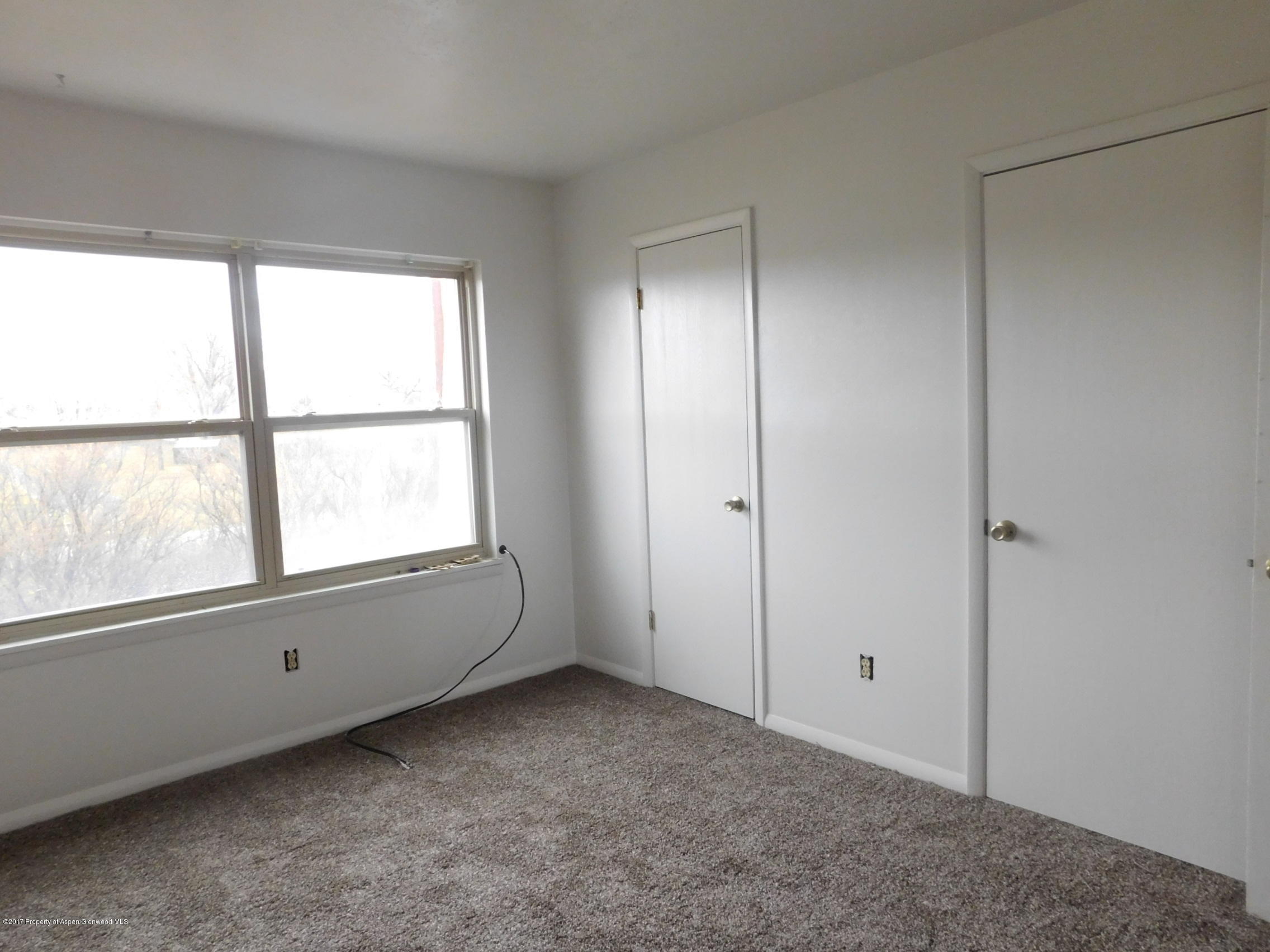 1393 West 2nd Street Craig, CO 81625 - Photo 6 of 16 a view of an empty room with a window