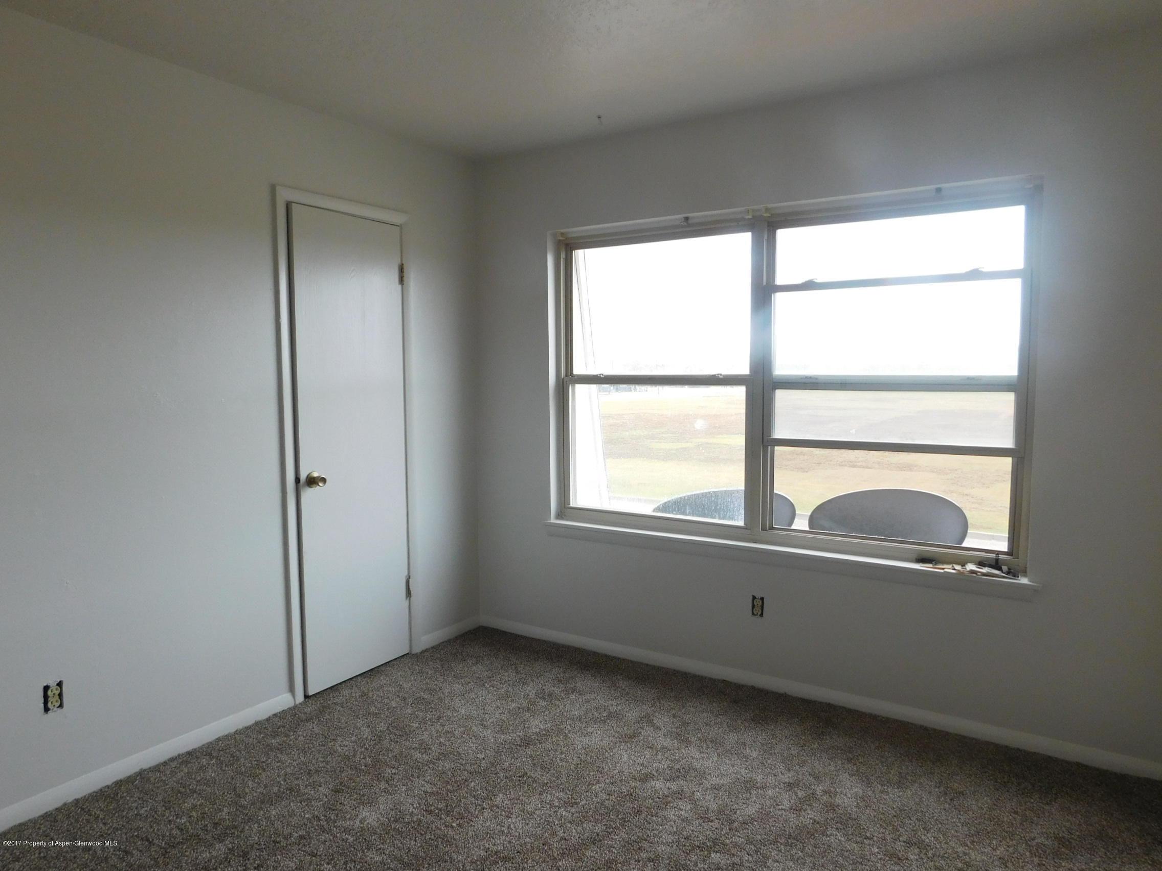1393 West 2nd Street Craig, CO 81625 - Photo 7 of 16 an empty room with a window