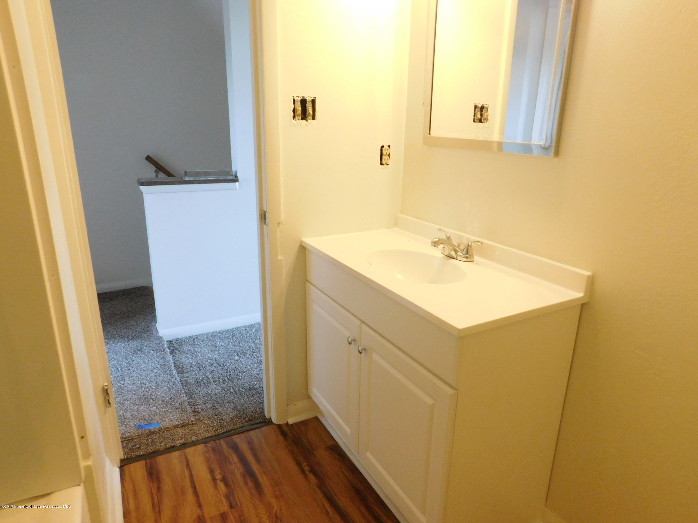 1393 West 2nd Street Craig, CO 81625 - Photo 8 of 16 a bathroom with a sink and a mirror
