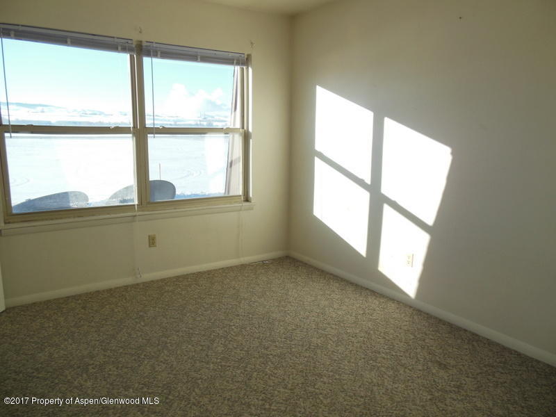 1393 West 2nd Street Craig, CO 81625 - Photo 9 of 16 an empty room with a window