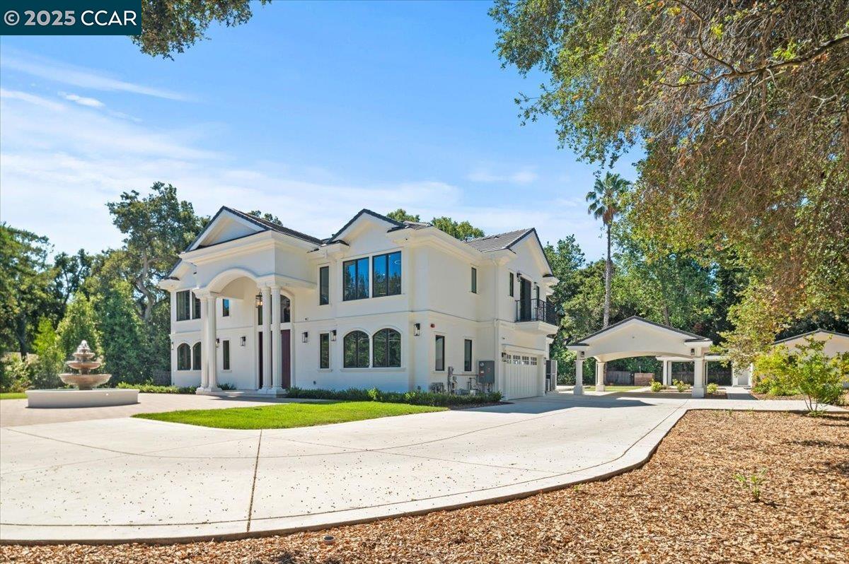 74 Middlefield Road Atherton, CA 94027 - Photo 46 of 51 a view of a white house with a large pool and large trees