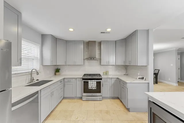 a kitchen with a sink stainless steel appliances and cabinets