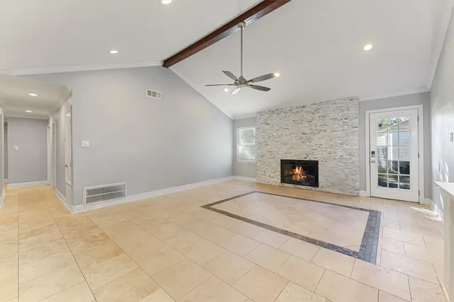 a view of an empty room with a fireplace