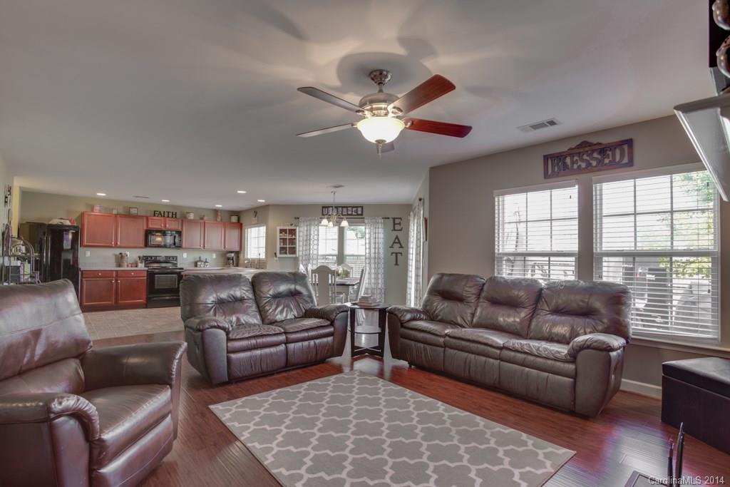 4411 Kiddle Lane Monroe, NC 28110 - Photo 13 of 24 a living room with furniture ceiling fan and a large window