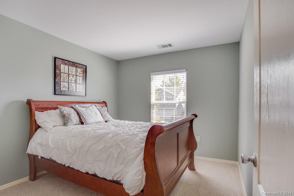 4411 Kiddle Lane Monroe, NC 28110 - Photo 17 of 24 a bed sitting in a bedroom next to a window