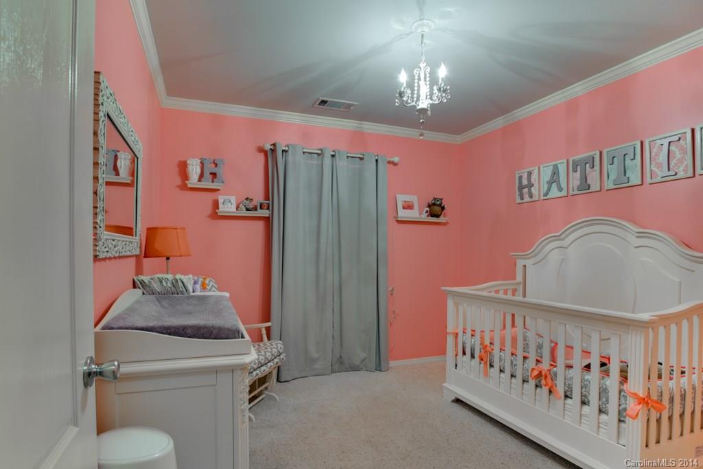 4411 Kiddle Lane Monroe, NC 28110 - Photo 18 of 24 a bedroom with furniture and a chandelier