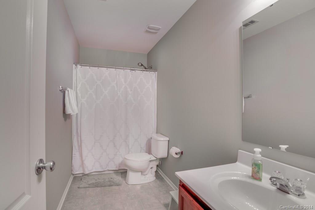 4411 Kiddle Lane Monroe, NC 28110 - Photo 19 of 24 a bathroom with a sink a toilet and shower