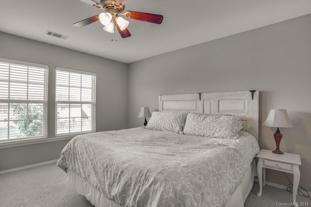 4411 Kiddle Lane Monroe, NC 28110 - Photo 20 of 24 a bedroom with a beds and a chandelier