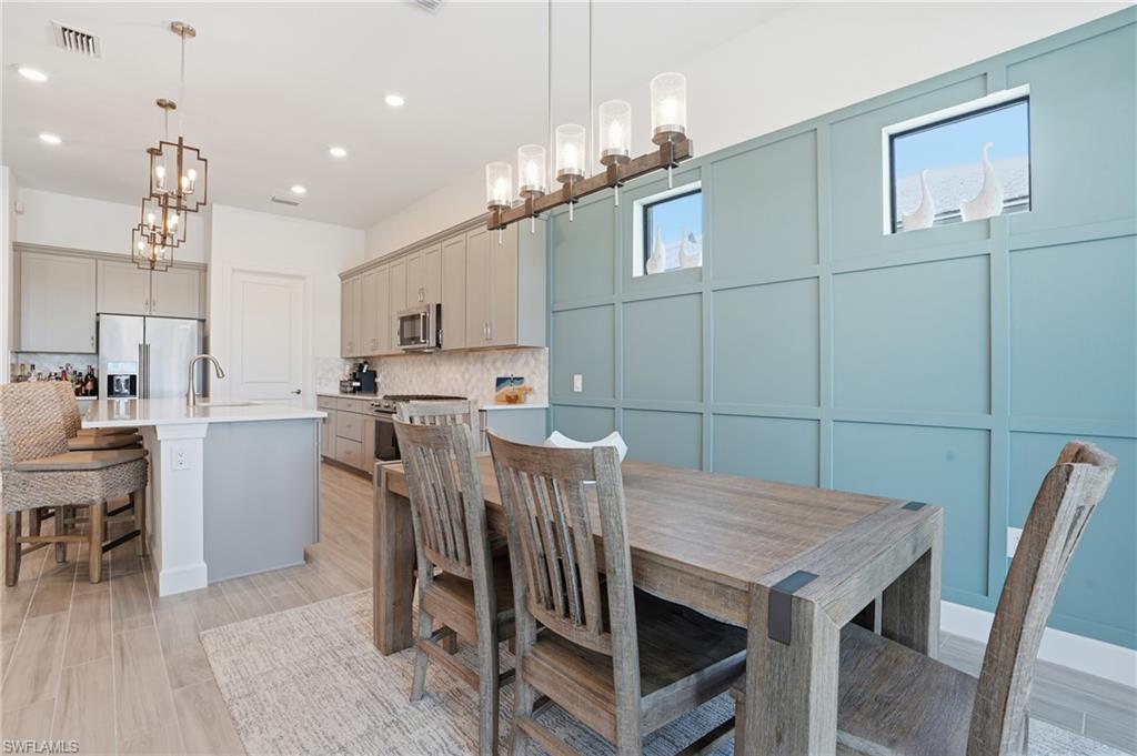 1872 Terreno Boulevard Naples, FL 34120 - Photo 15 of 50 a view of a dining room with furniture and wooden floor