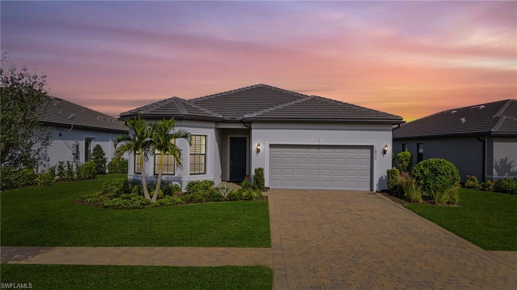 1872 Terreno Boulevard Naples, FL 34120 - Photo 2 of 50 a front view of a house with a garden and plants
