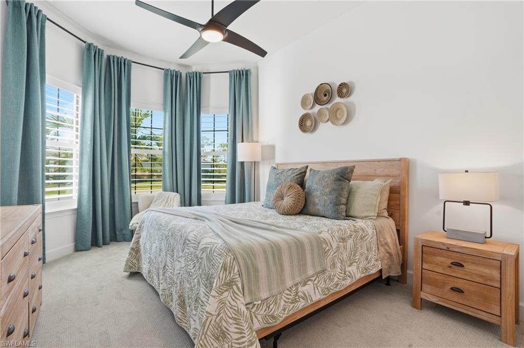 1872 Terreno Boulevard Naples, FL 34120 - Photo 24 of 50 a bedroom with a large bed and a window
