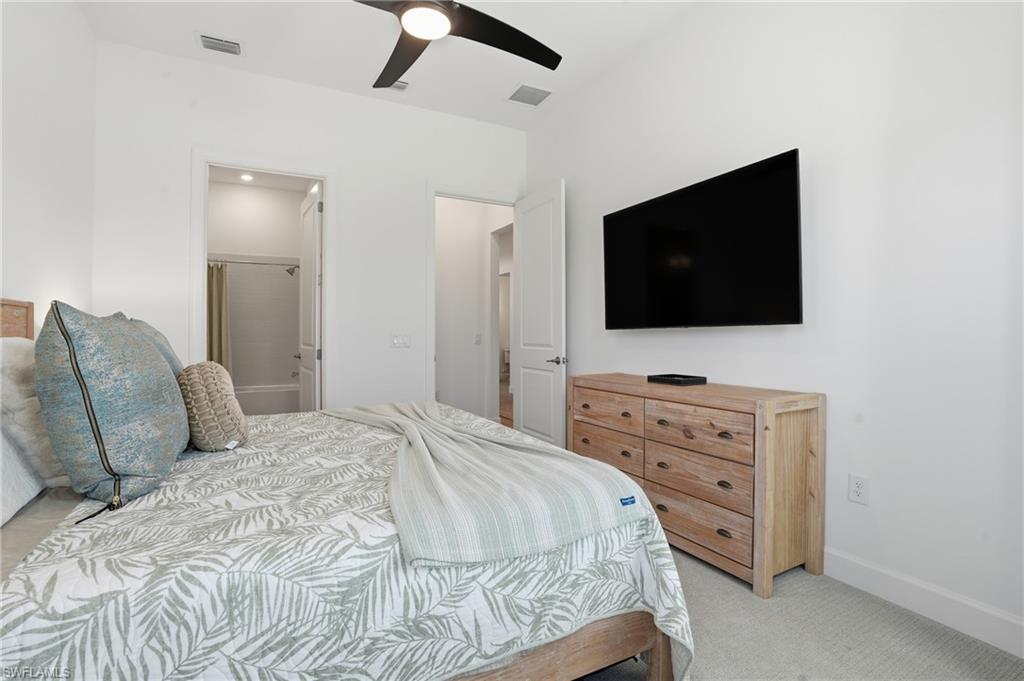 1872 Terreno Boulevard Naples, FL 34120 - Photo 25 of 50 a bedroom with a bed and a flat screen tv