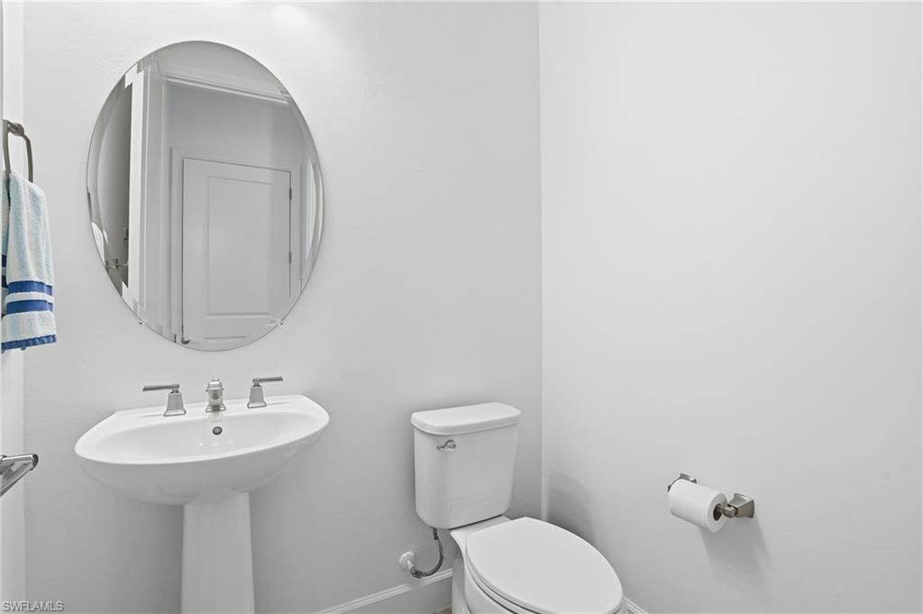 1872 Terreno Boulevard Naples, FL 34120 - Photo 29 of 50 a bathroom with a toilet sink and mirror