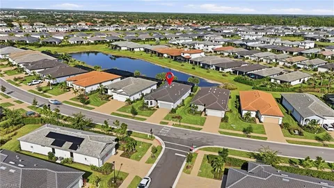 an aerial view of residential houses with outdoor space and swimming pool