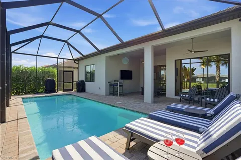 a view of a patio with table and chairs under an umbrella