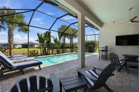 a view of a patio with a table chairs and a backyard