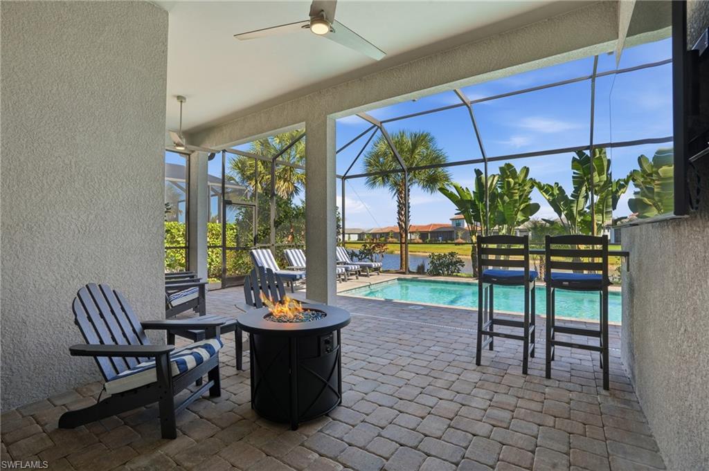 1872 Terreno Boulevard Naples, FL 34120 - Photo 38 of 50 a view of a patio with a dining table and chairs