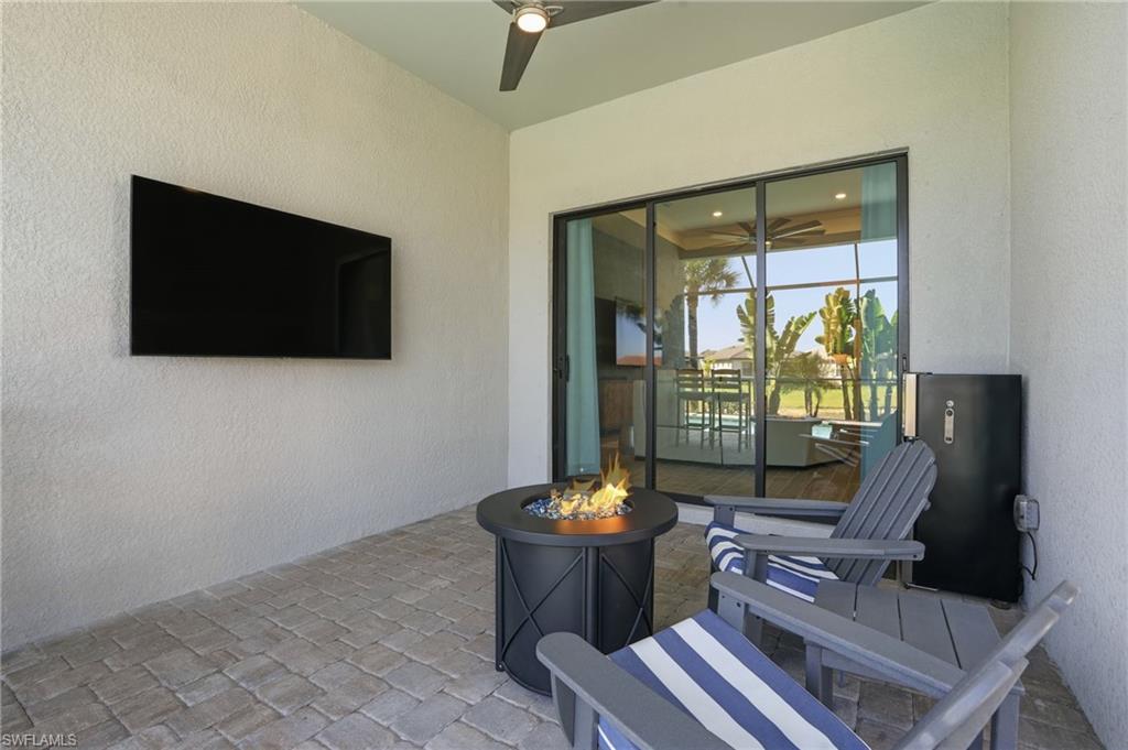 1872 Terreno Boulevard Naples, FL 34120 - Photo 39 of 50 a living room with furniture and a flat screen tv