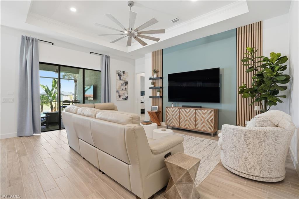1872 Terreno Boulevard Naples, FL 34120 - Photo 6 of 50 a living room with furniture and a flat screen tv