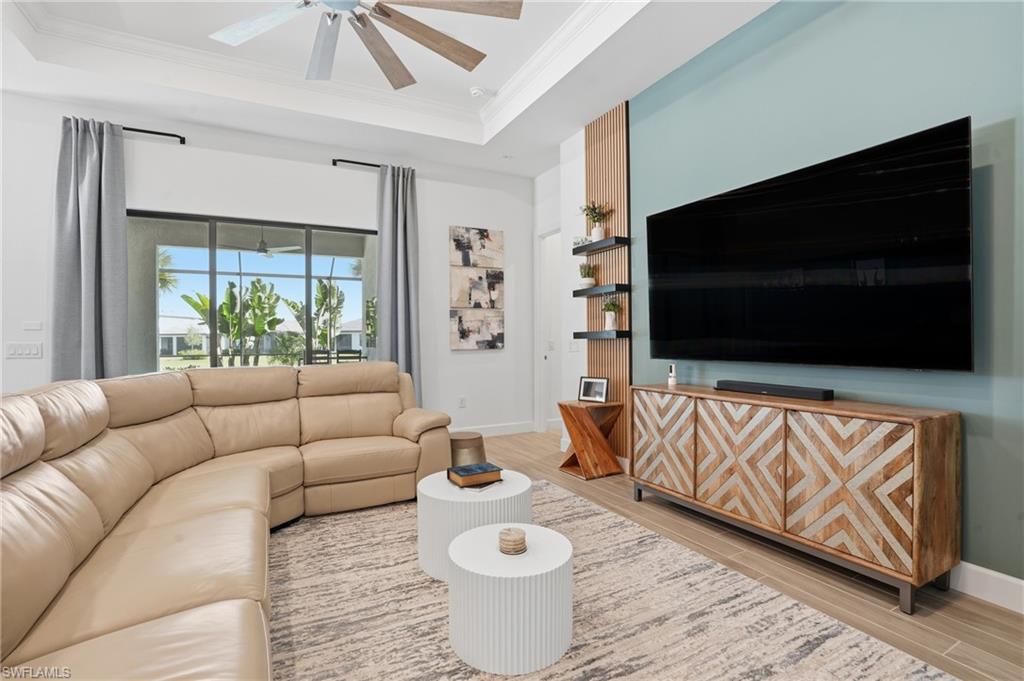 1872 Terreno Boulevard Naples, FL 34120 - Photo 7 of 50 a living room with furniture and a flat screen tv