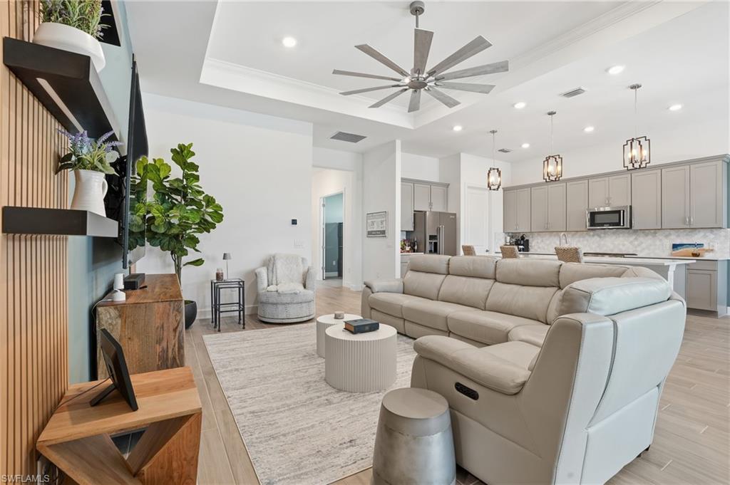1872 Terreno Boulevard Naples, FL 34120 - Photo 8 of 50 a living room with furniture a chandelier and a dining room