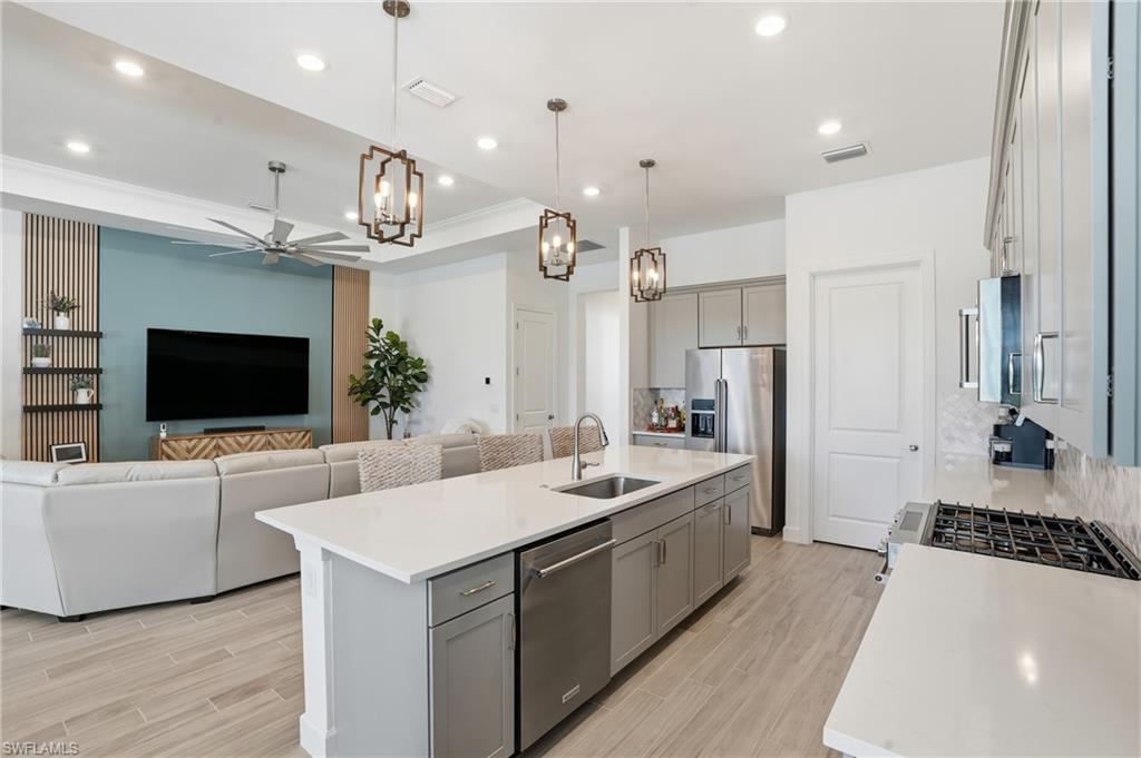 1872 Terreno Boulevard Naples, FL 34120 - Photo 9 of 50 a large kitchen with a counter space a sink stainless steel appliances and cabinets