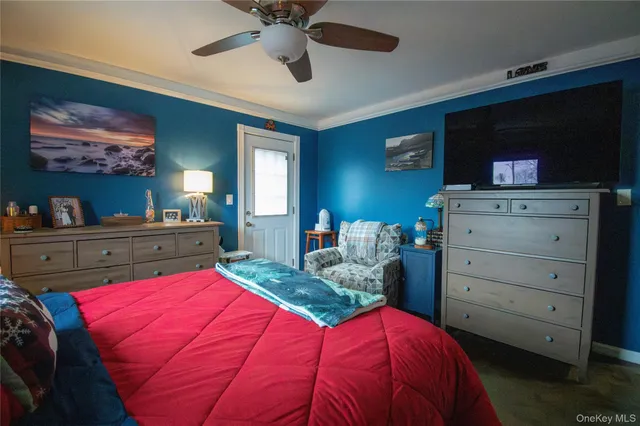 a bedroom with a bed and a television