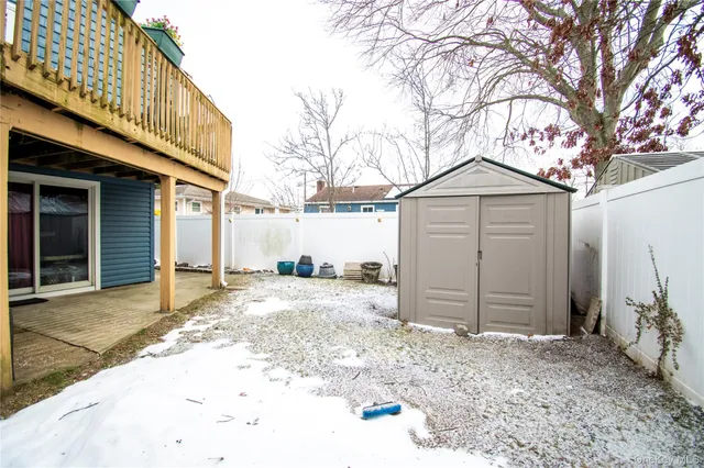 a front view of a house with a yard covered in snow