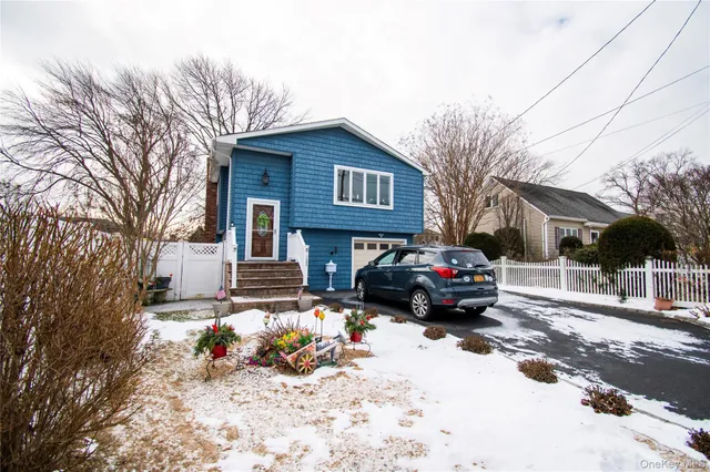 a car parked in front of a white house