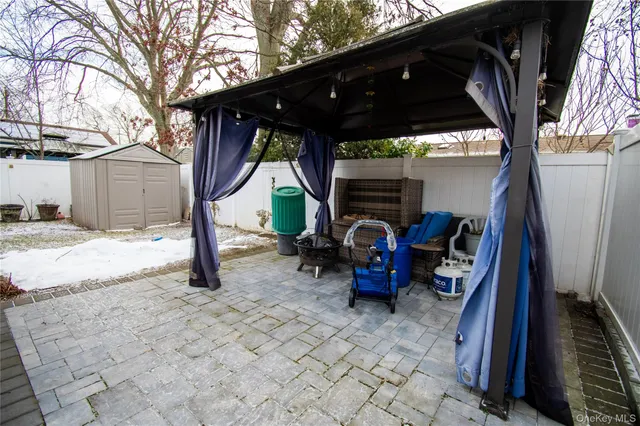 a view of house with backyard space and seating