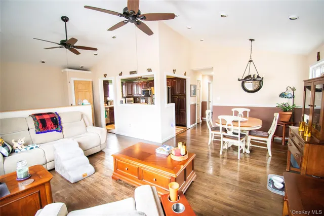 a living room with furniture a dining table and chairs
