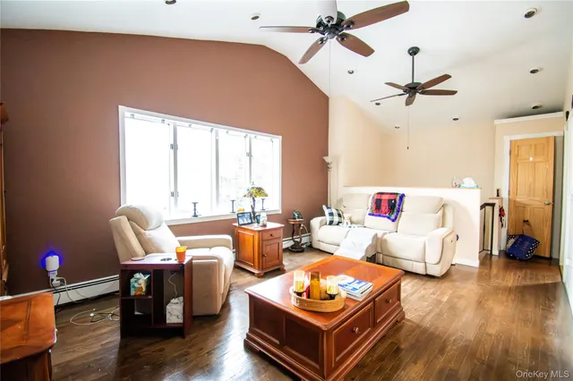 a living room with furniture a wooden floor and a window