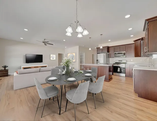 a view of a dining room with furniture wooden floor and a chandelier