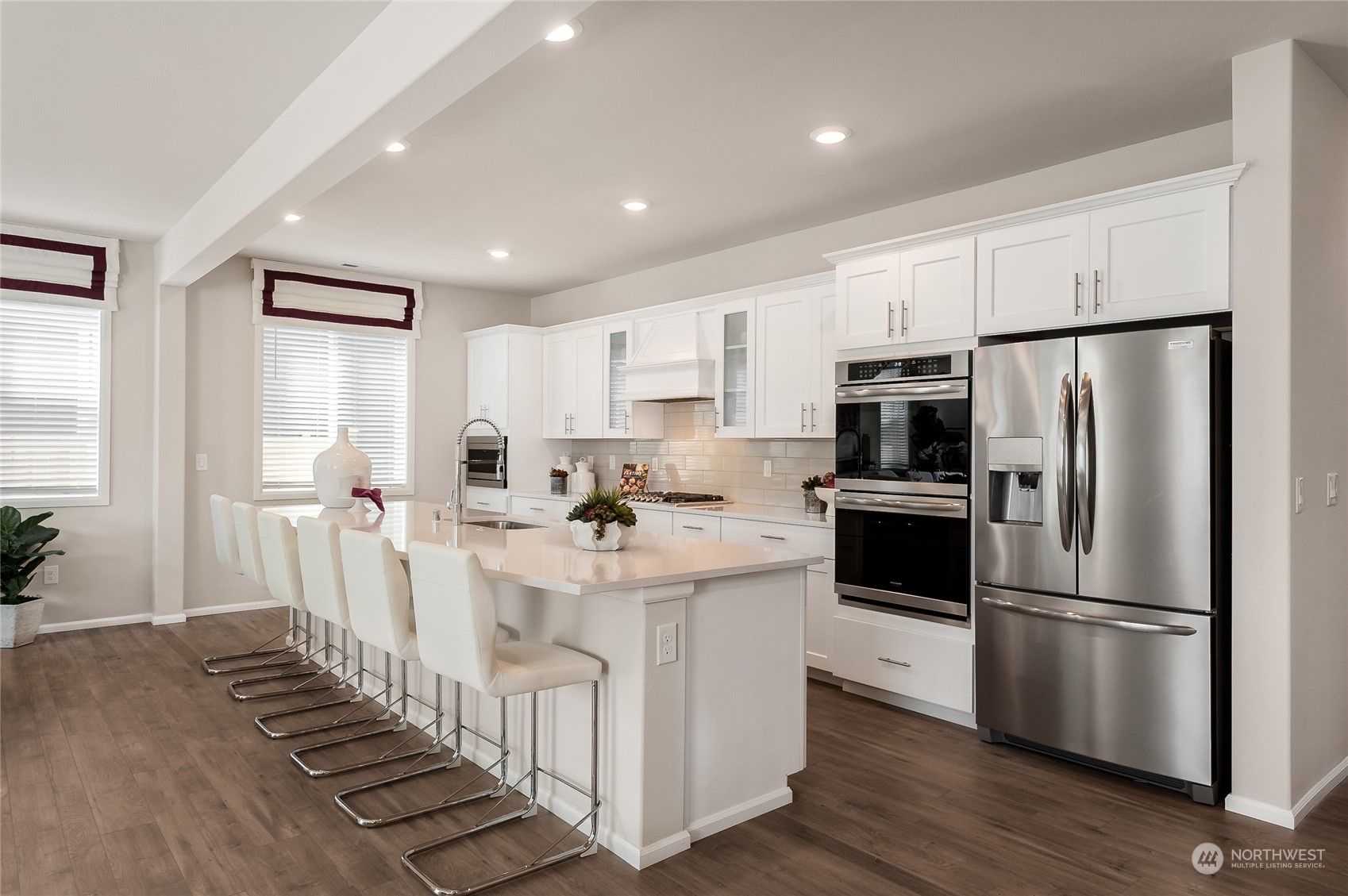 4027 233rd Street Southeast, Unit 11 Bothell, WA 98021 - Photo 8 of 18 a kitchen with white cabinets and stainless steel appliances