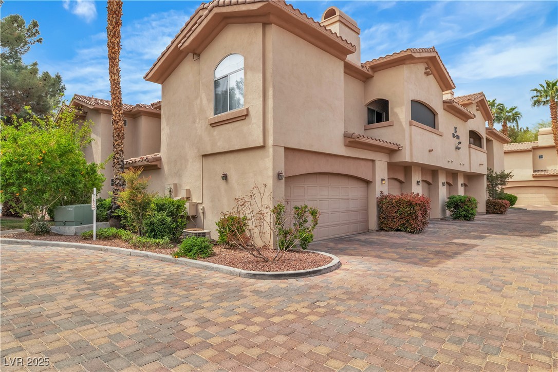 2050 West Warm Springs Road, Unit 1822 Henderson, NV 89014 - Photo 2 of 55 Mediterranean / spanish-style home with driveway, stucco siding, an attached garage, and a tile roof