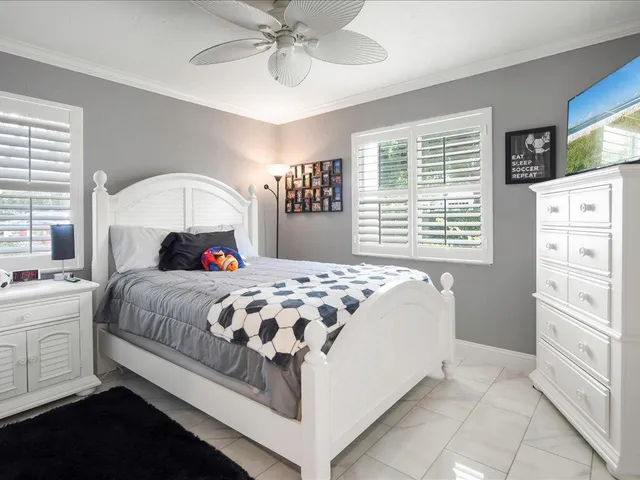 a bedroom with a large bed and a window