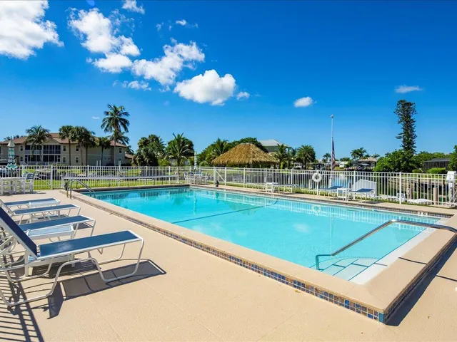 a view of swimming pool with outdoor seating and yard in back