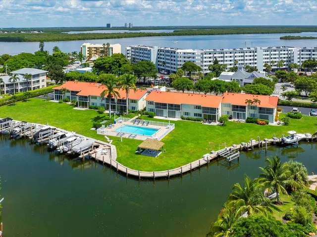 an aerial view of residential houses with outdoor space and lake view