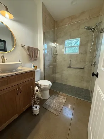 a bathroom with a sink toilet a mirror and shower