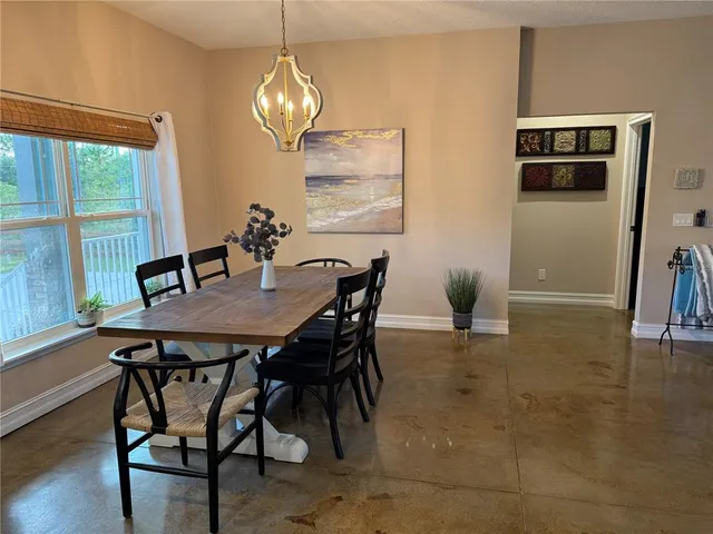 a view of a dining room with furniture wooden floor and a chandelier
