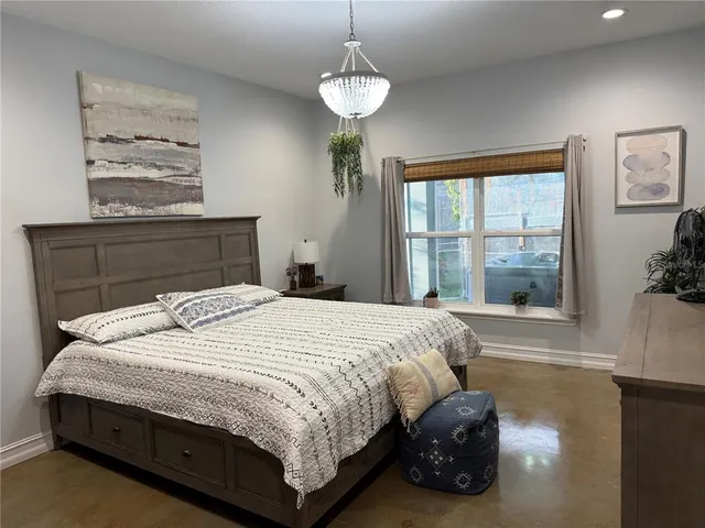 a bedroom with a bed and window