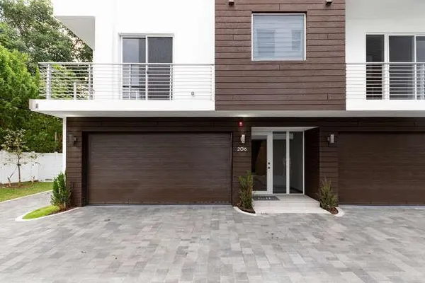 a view of a house with a yard and garage