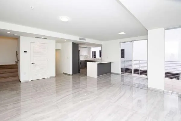 a kitchen with stainless steel appliances granite countertop a sink and a stove top oven with wooden floor