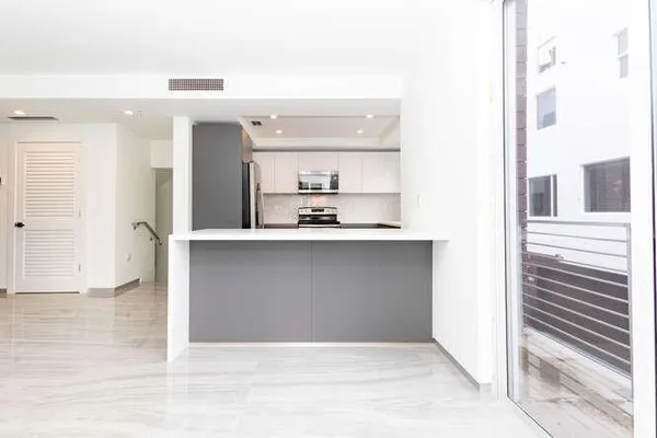 a stove top oven sitting inside of a kitchen