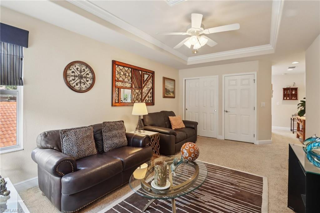 19612 Tesoro Way Estero, FL 33967 - Photo 11 of 50 a living room with furniture a clock and a window