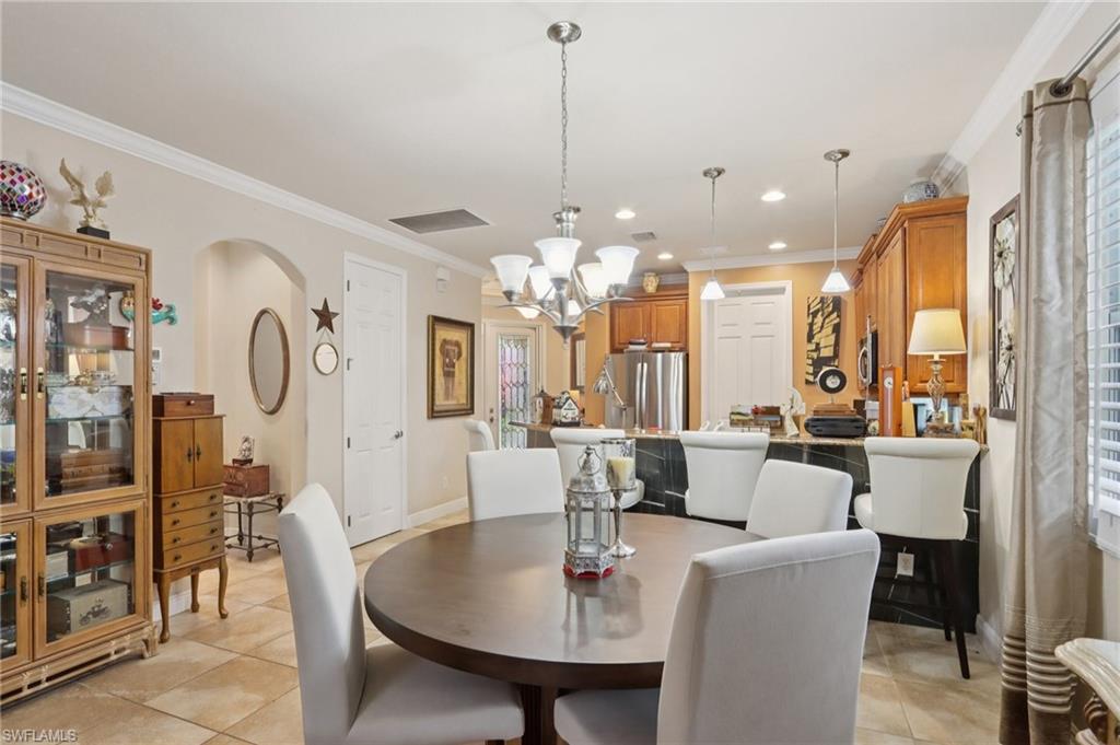 19612 Tesoro Way Estero, FL 33967 - Photo 13 of 50 a view of a dining room with furniture window and wooden floor