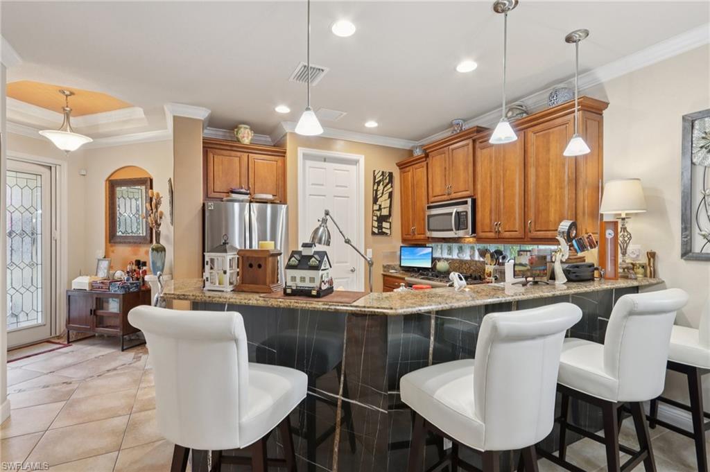 19612 Tesoro Way Estero, FL 33967 - Photo 14 of 50 a large kitchen with a table and chairs