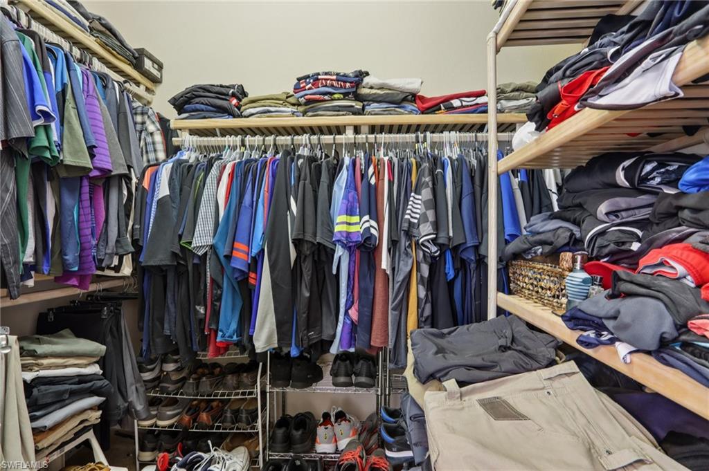 19612 Tesoro Way Estero, FL 33967 - Photo 23 of 50 a view of walk in closet with clothes and shoes