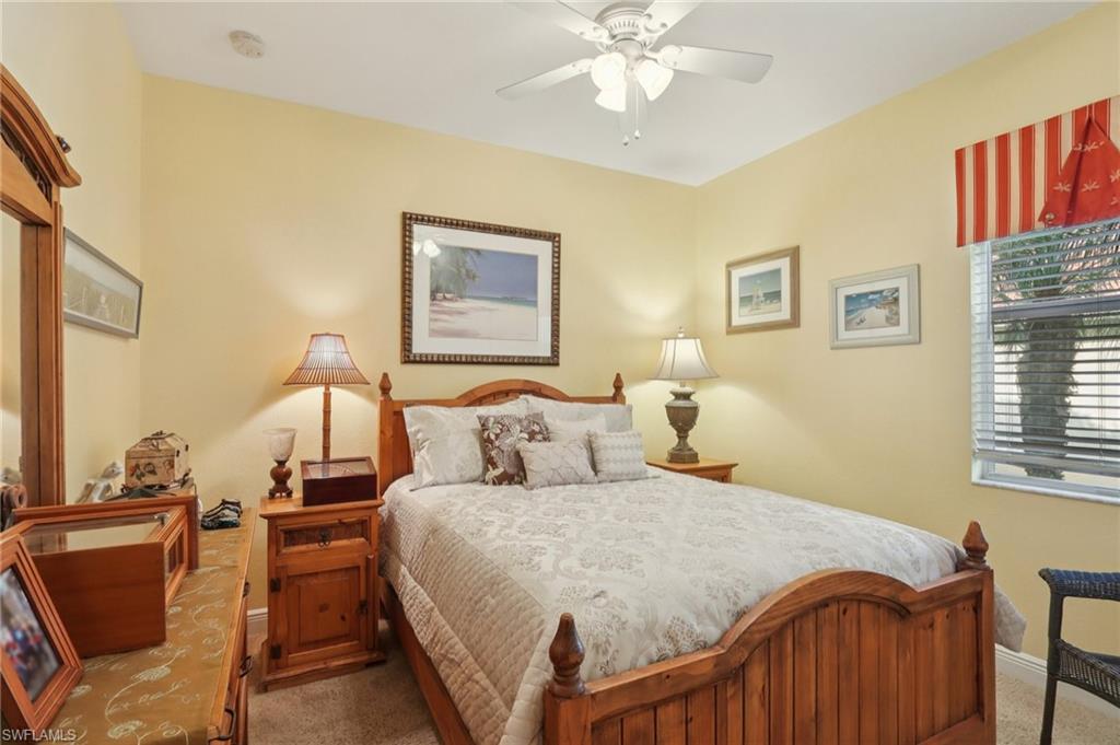 19612 Tesoro Way Estero, FL 33967 - Photo 26 of 50 a bedroom with a bed and wooden floor